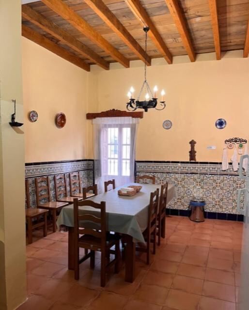 Communal dining room with hand painted tiles and beamed ceiling